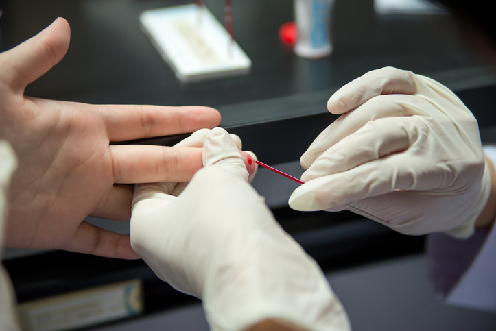 Close-up detail of blood being collected by the use of a capillary tube. Healthcare and medicine concept.